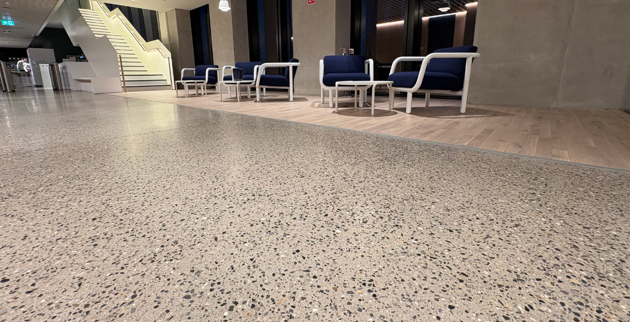 Polished exposed concrete aggregate floors in a modern chic seating area