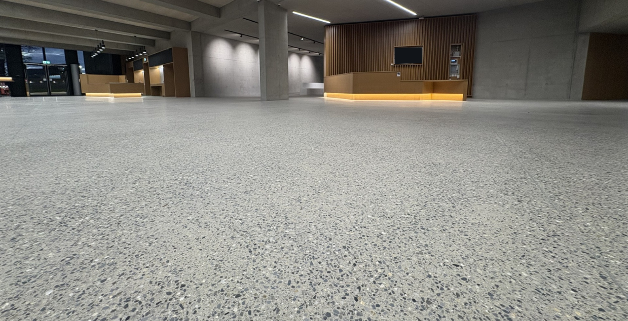 White polished exposed concrete aggregate floors in busy campus